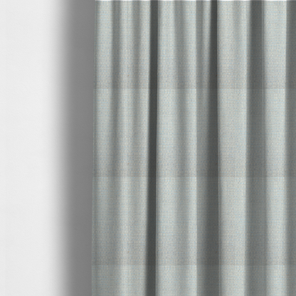 The fabric used to create these made-to-measure curtains is a material features a dense, light-toned weave with a pale cream and off-white base, subtly interlaced with delicate horizontal flecks of soft baby blue and light grey threads throughout.