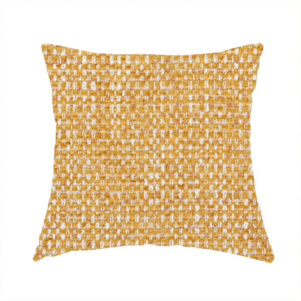 The fabric used to create this handmade cushion is a material features a dense, multi-toned weave with a warm mustard yellow and ochre base, intricately interlaced with horizontal flecks of crisp white and soft beige threads throughout.