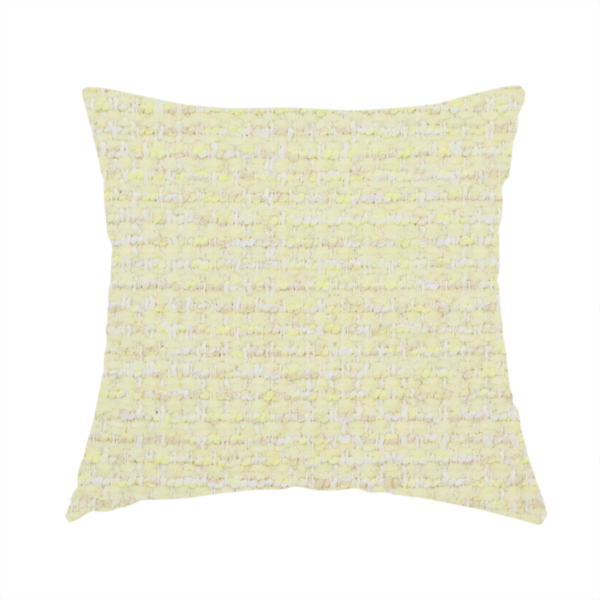 The fabric used to create this handmade cushion is a material features a dense, light-toned weave with a pale cream base, subtly interlaced with horizontal flecks of soft pastel yellow and light beige threads throughout.