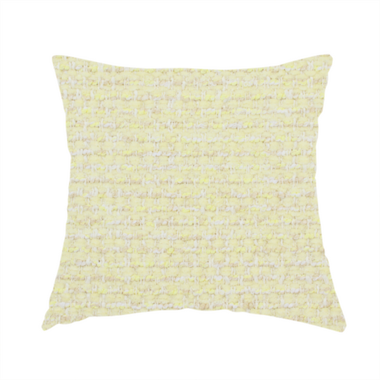 The fabric used to create this handmade cushion is a material features a dense, light-toned weave with a pale cream base, subtly interlaced with horizontal flecks of soft pastel yellow and light beige threads throughout.