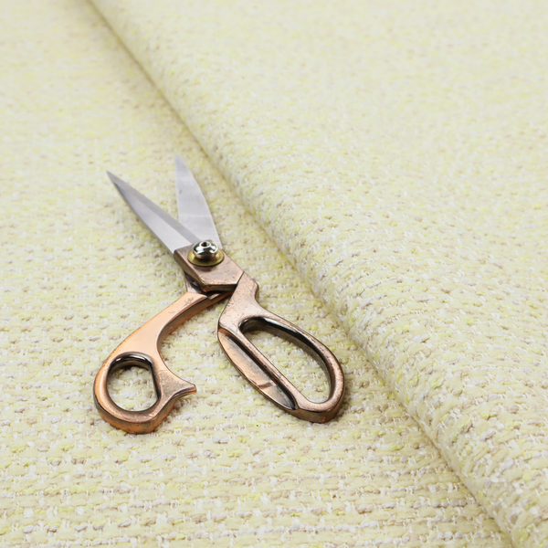 The material features a dense, light-toned weave with a pale cream base, subtly interlaced with horizontal flecks of soft pastel yellow and light beige threads throughout.