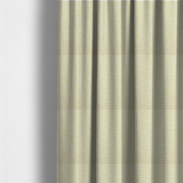The fabric used to create these made-to-measure curtains is a material features a dense, light-toned weave with a pale cream base, subtly interlaced with horizontal flecks of soft pastel yellow and light beige threads throughout.