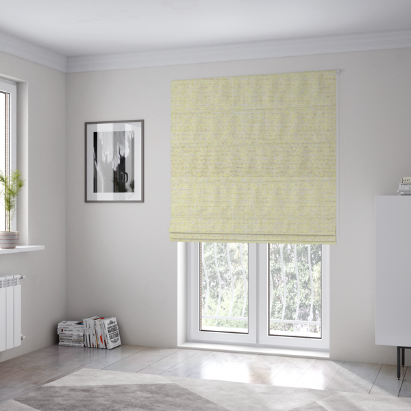 The fabric used to create these Roman blinds is a material features a dense, light-toned weave with a pale cream base, subtly interlaced with horizontal flecks of soft pastel yellow and light beige threads throughout.