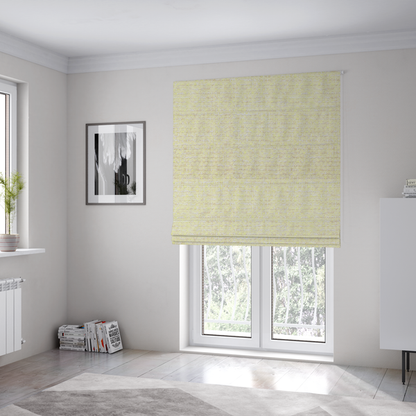 The fabric used to create these Roman blinds is a material features a dense, light-toned weave with a pale cream base, subtly interlaced with horizontal flecks of soft pastel yellow and light beige threads throughout.