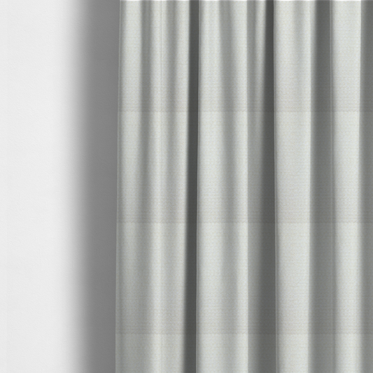 The fabric used to create these made-to-measure curtains is a material features a dense, minimalist weave in a uniform bright cream or off-white colour, highlighting the subtle horizontal texture of the interlaced threads.