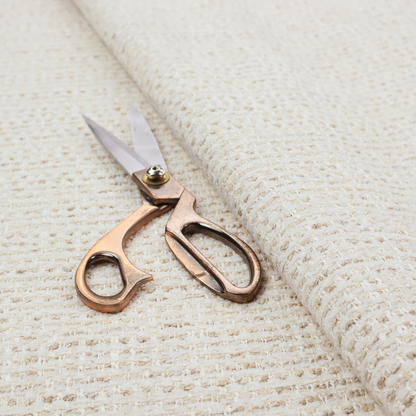 The material features a dense, neutral weave with a light cream base, subtly interlaced with horizontal flecks of soft beige and oatmeal-coloured threads throughout.