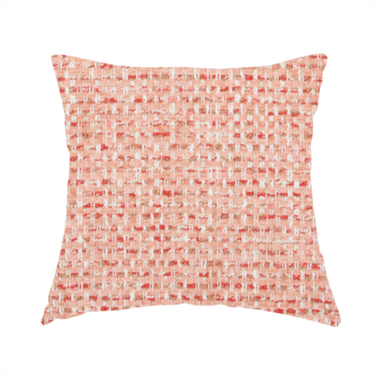 The fabric used to create this handmade cushion is a material features a dense, warm-toned weave with a soft coral pink and peach base, intricately interlaced with horizontal flecks of terracotta red, beige, and white threads throughout.