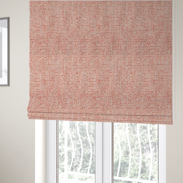 The fabric used to create these Roman blinds is a material features a dense, warm-toned weave with a soft coral pink and peach base, intricately interlaced with horizontal flecks of terracotta red, beige, and white threads throughout.