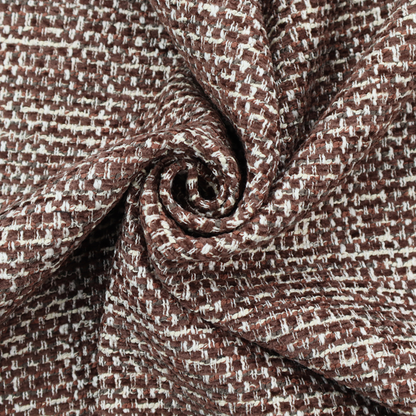 The material features a dense, multi-toned weave with a deep chocolate brown base, intricately interlaced with prominent horizontal flecks of crisp white and dark charcoal grey threads throughout.
