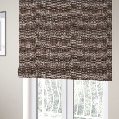 The fabric used to create these Roman blinds is a material features a dense, multi-toned weave with a deep chocolate brown base, intricately interlaced with prominent horizontal flecks of crisp white and dark charcoal grey threads throughout.