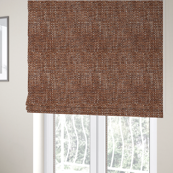 The fabric used to create these Roman blinds is a material features a dense, multi-toned weave with a warm rust orange and terracotta base, intricately interlaced with prominent horizontal flecks of crisp white and dark charcoal brown threads throughout.