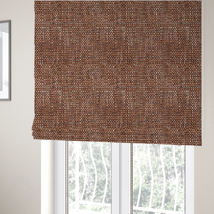 The fabric used to create these Roman blinds is a material features a dense, multi-toned weave with a warm rust orange and terracotta base, intricately interlaced with prominent horizontal flecks of crisp white and dark charcoal brown threads throughout.