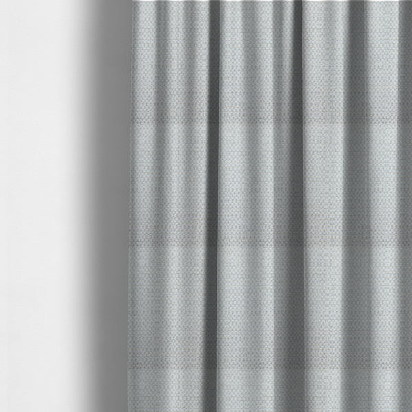 The fabric used to create these made-to-measure curtains is a material features a dense, multi-toned neutral weave with a pale grey and silver-toned base, intricately interlaced with horizontal flecks of soft cream and off-white threads throughout.