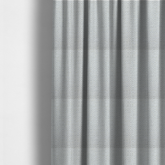 The fabric used to create these made-to-measure curtains is a material features a dense, multi-toned neutral weave with a pale grey and silver-toned base, intricately interlaced with horizontal flecks of soft cream and off-white threads throughout.