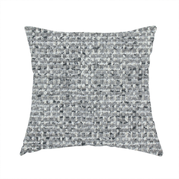 The fabric used to create this handmade cushion is a material features a dense, multi-toned weave with a mid-grey base, intricately interlaced with horizontal flecks of crisp white and dark charcoal grey threads throughout.