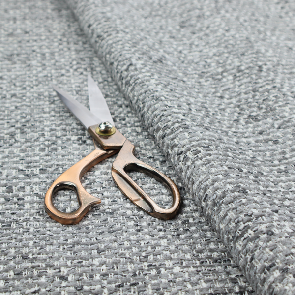 The material features a dense, multi-toned weave with a mid-grey base, intricately interlaced with horizontal flecks of crisp white and dark charcoal grey threads throughout.