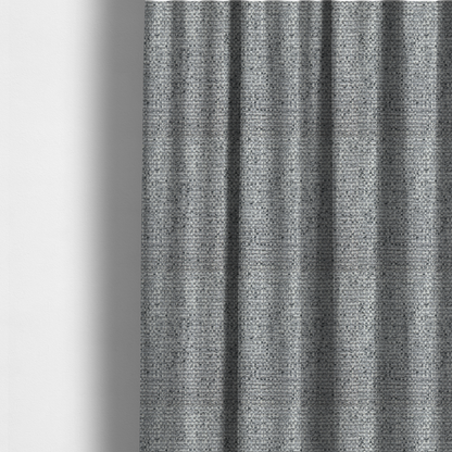 The fabric used to create these made-to-measure curtains is a material features a dense, multi-toned weave with a mid-grey base, intricately interlaced with horizontal flecks of crisp white and dark charcoal grey threads throughout.