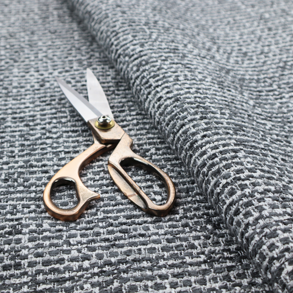 The material features a dense, multi-toned weave with a dark charcoal grey and slate base, intricately interlaced with prominent horizontal flecks of crisp white and lighter grey threads throughout.