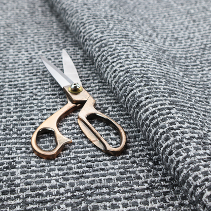 The material features a dense, multi-toned weave with a dark charcoal grey and slate base, intricately interlaced with prominent horizontal flecks of crisp white and lighter grey threads throughout.