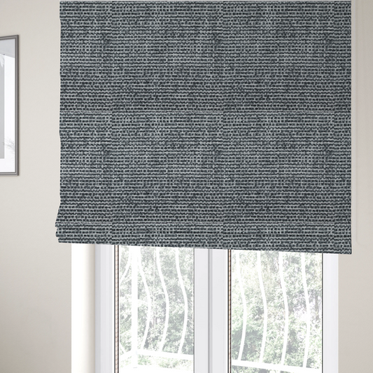 the fabric used to create these Roman blinds is a  material features a dense, multi-toned weave with a dark charcoal grey and slate base, intricately interlaced with prominent horizontal flecks of crisp white and lighter grey threads throughout.