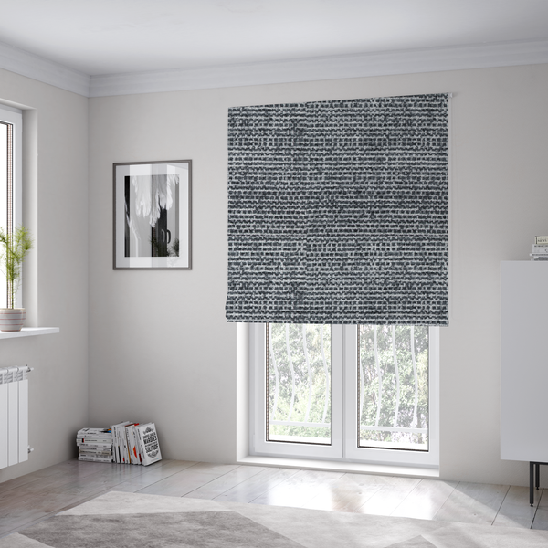 the fabric used to create these Roman blinds is a  material features a dense, multi-toned weave with a dark charcoal grey and slate base, intricately interlaced with prominent horizontal flecks of crisp white and lighter grey threads throughout.