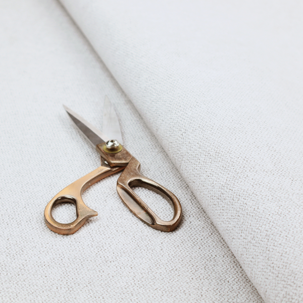 A light grey or off-white woven fabric with a fine, textured basket weave pattern.