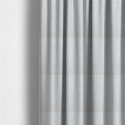The fabric used to create these made-to-measure curtains is a light grey or off-white woven fabric with a fine, textured basket weave pattern.