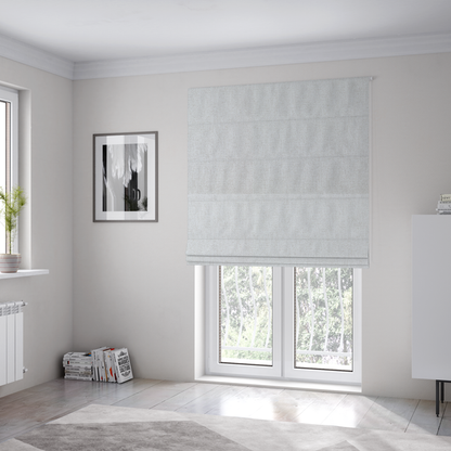 The fabric used to create these Roman blinds is a light grey or off-white woven fabric with a fine, textured basket weave pattern.