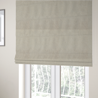 The fabric used to create these Roman blinds is a beige or oatmeal woven fabric with a fine, textured basket weave pattern.