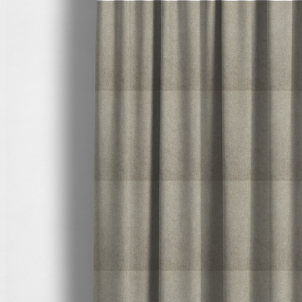The fabric used to create these made-to-measure curtains is a taupe or dark beige woven fabric with a fine, heathered texture.
