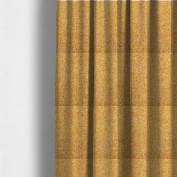 The fabric used to create these made-to-measure curtains is a vibrant mustard yellow woven fabric with a fine, heathered texture.