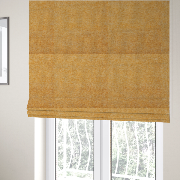 The fabric used to create these Roman blinds is a vibrant mustard yellow woven fabric with a fine, heathered texture.