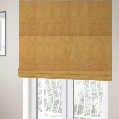 The fabric used to create these Roman blinds is a vibrant mustard yellow woven fabric with a fine, heathered texture.
