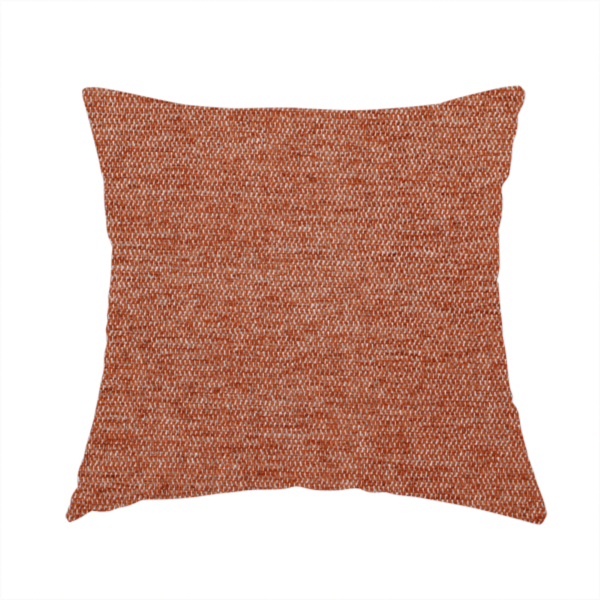 The fabric used to create this handmade cushion is a vibrant terracotta orange woven fabric with a fine, heathered texture.
