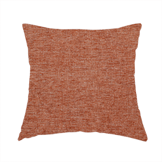 The fabric used to create this handmade cushion is a vibrant terracotta orange woven fabric with a fine, heathered texture.