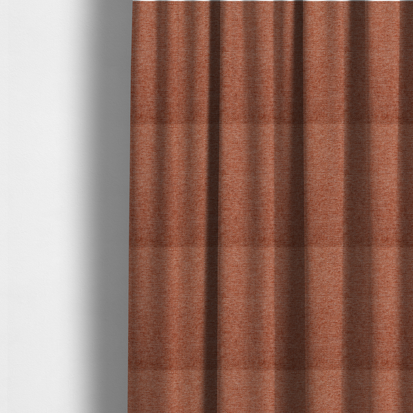 The fabric used to create these made-to-measure curtains is a vibrant terracotta orange woven fabric with a fine, heathered texture.