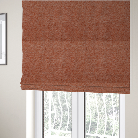 The fabric used to create these Roman blinds is a vibrant terracotta orange woven fabric with a fine, heathered texture.
