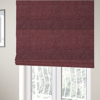 The fabric used to create these Roman blinds is a rich burgundy red woven fabric with a fine, heathered texture.