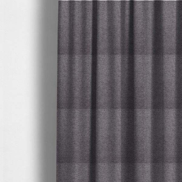 The fabric used to create these made-to-measure curtains is a charcoal grey woven fabric with a fine, heathered texture.