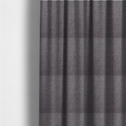 The fabric used to create these made-to-measure curtains is a charcoal grey woven fabric with a fine, heathered texture.