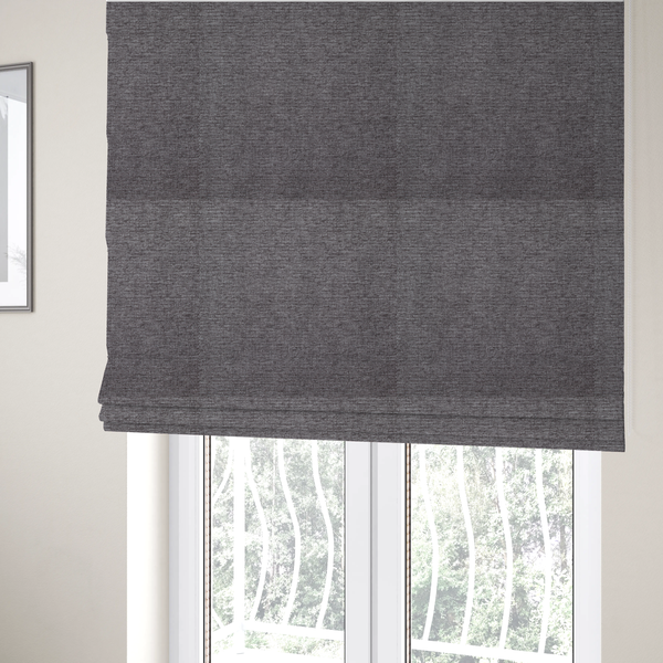 The fabric used to create these Roman blinds is a charcoal grey woven fabric with a fine, heathered texture.