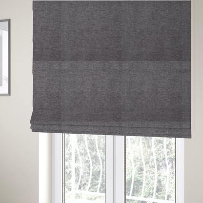 The fabric used to create these Roman blinds is a charcoal grey woven fabric with a fine, heathered texture.