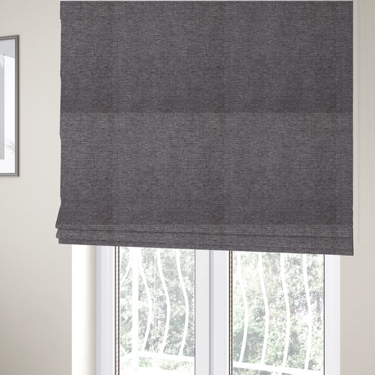The fabric used to create these Roman blinds is a charcoal grey woven fabric with a fine, heathered texture.