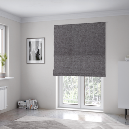 The fabric used to create these Roman blinds is a charcoal grey woven fabric with a fine, heathered texture.
