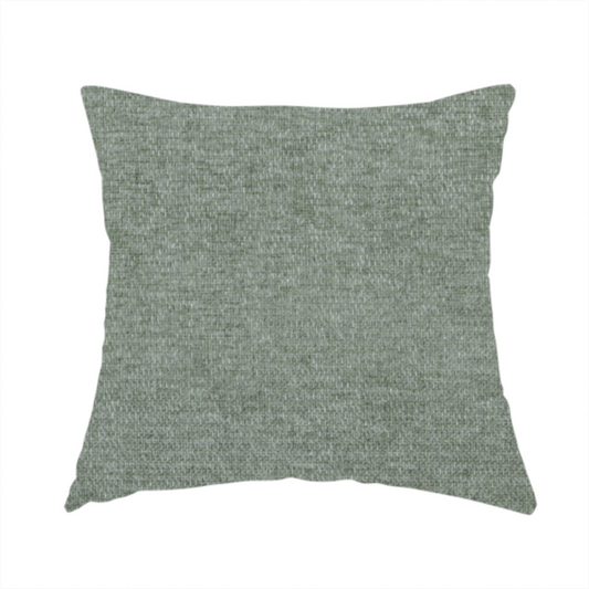 The fabric used to create this handmade cushion is a sage green woven fabric with a fine, heathered texture.