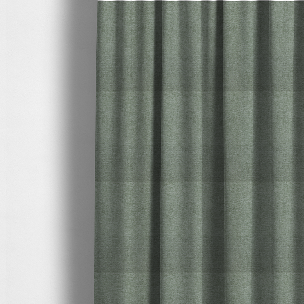 The fabric used to create these made-to-measure curtains is a sage green woven fabric with a fine, heathered texture.