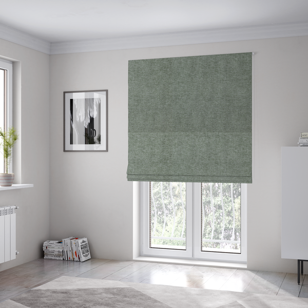 The fabric used to create these Roman blinds is a sage green woven fabric with a fine, heathered texture.