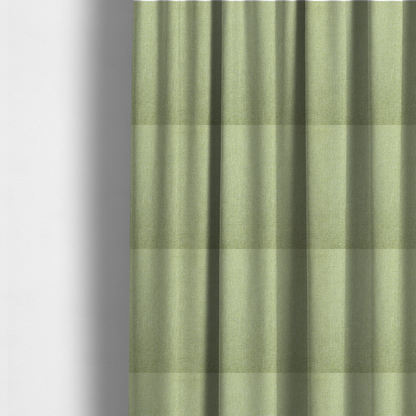 The fabric used to create these made-to-measure curtains is a light lime green woven fabric with a fine, heathered texture.