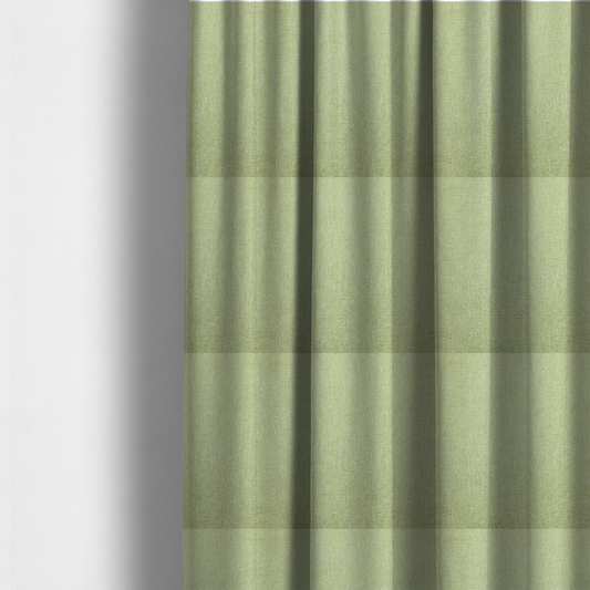 The fabric used to create these made-to-measure curtains is a light lime green woven fabric with a fine, heathered texture.