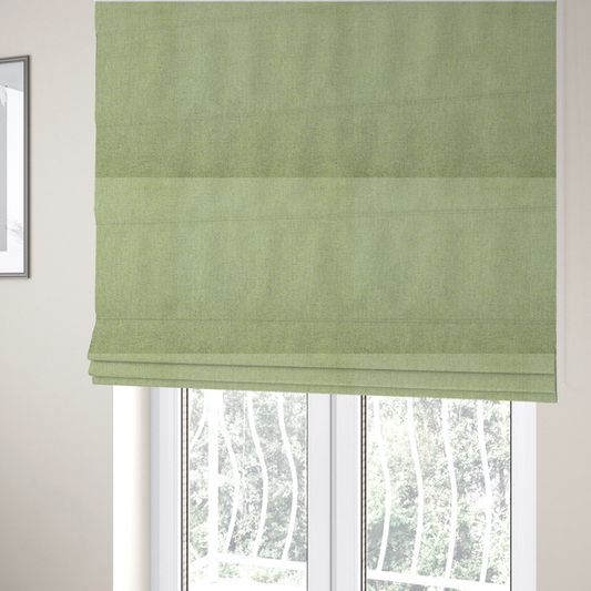 The fabric used to create these Roman blinds is a light lime green woven fabric with a fine, heathered texture.